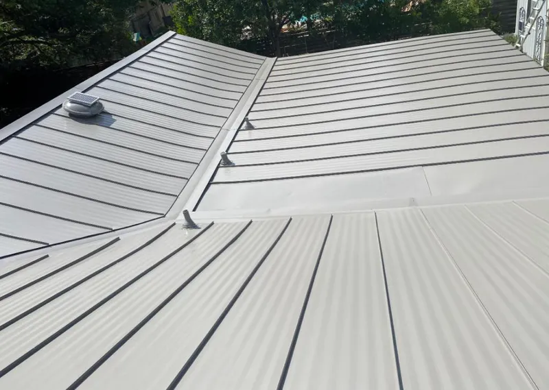 Solar attic fan installed on a metal roof for Roof Ventilation in Valley Stream
